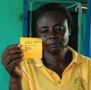 Nurse holding malaria statistics